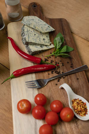 Flat lay with cherry tomatoes, cheese, hot peppers, spices and basil.の写真素材