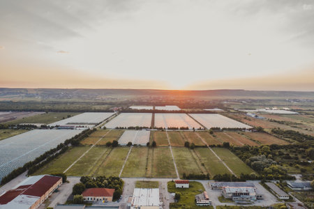 Aerial top view of greenhouse plant. Agronomy, year-round climate control and yield, indoor farming, heat recovery, power consumption and organic plant protection concept. Background image, copy spaceの写真素材