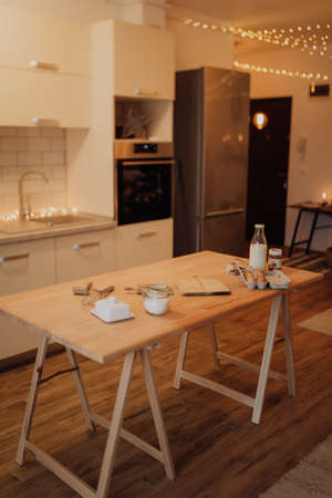 fresh ingredients for the dough on the wooden table in the Christmas atmosphere