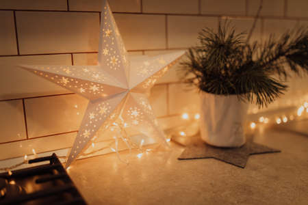 star-shaped Christmas decoration with light inside placed on the table