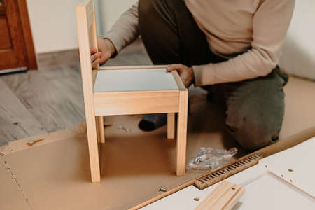 man assembling new furniture bought for homeの写真素材