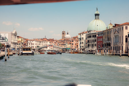 The Grand Canal of Venice gracefully winds through the heart of this romantic city, adorned with colorful buildings and bustling boats.の写真素材