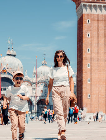 Mother and son walking in Piazza San Marco in Venice, Italyの写真素材