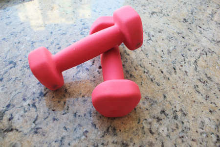 pink dumbbell on marble floorの写真素材
