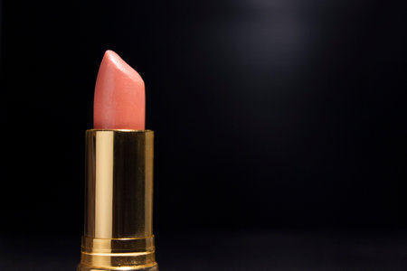 Golden Lipstick for Pink Color, in Black background for Advertising.の写真素材