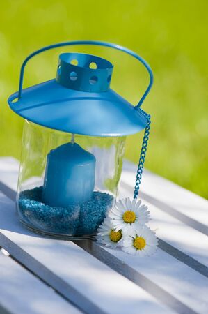 Garden lantern with daisy flowersの写真素材