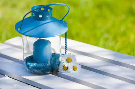 Garden lantern with daisy flowersの写真素材