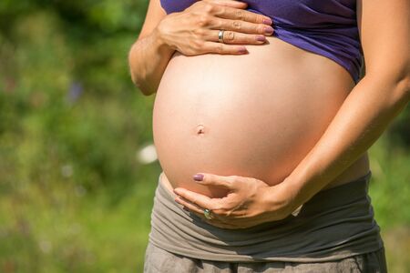 Pregnant woman holding her belly