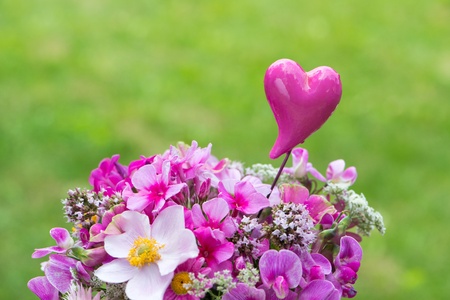 Pink garden flowers in a small watering canの写真素材