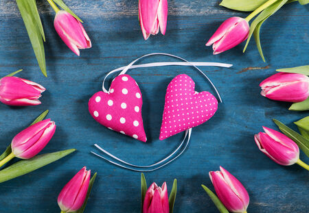 Pink hearts with tulips on wooden backgroundの写真素材