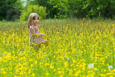 Gril in a spring meadowの写真素材