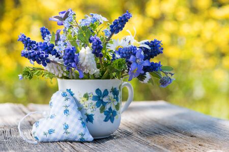 Spring flower bouquet in a coffee cupの写真素材