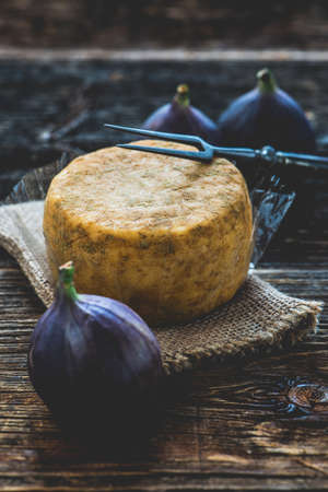 Raw milk cheese on a wooden plate