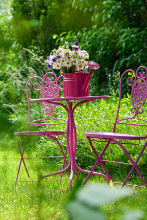 Wild flower bouquet on a garden chairの写真素材