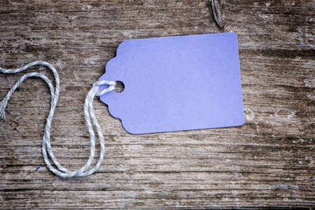 Purple paper label on wooden backgroundの写真素材