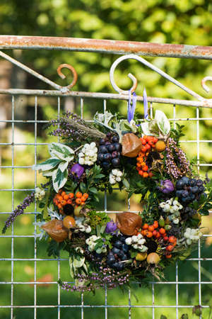 Colorful autumn wreath on a garden benchの写真素材