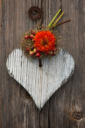 Wooden heart with little flowersの写真素材