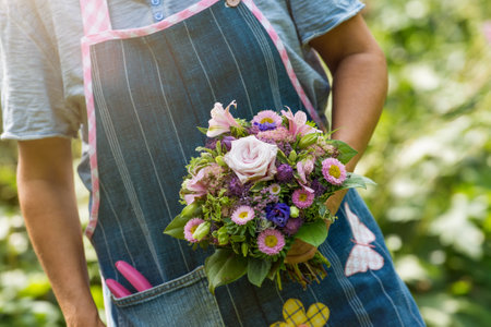 Florist holding a bouquet of flowersの写真素材