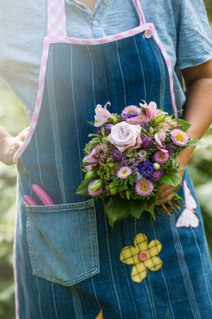Florist holding a bouquet of flowersの写真素材