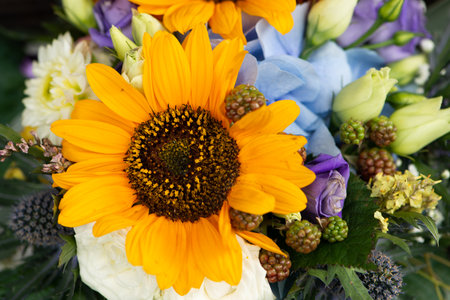 Bouquet of flowers in different colors and sizes with sunflower
