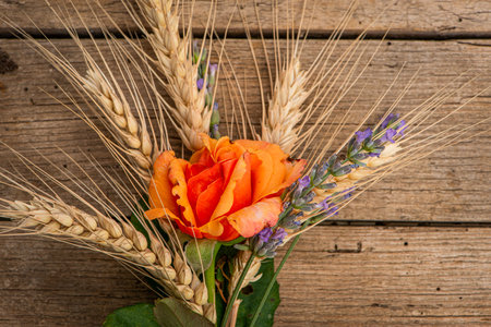 Rose with wheat and lavender on wooden backgroundの写真素材
