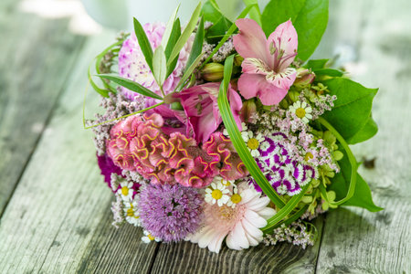 Romantic bouquet on a wooden table with nature backgroundの写真素材