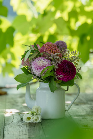 Romantic bouquet on a wooden table with nature backgroundの写真素材
