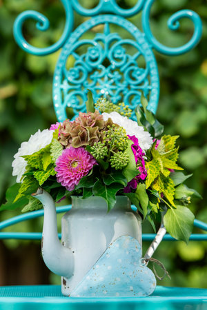 Flower bouquet in an old enamel potの写真素材