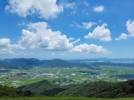 Beautiful landscape of green mountain and blue sky with white clouds.の写真素材
