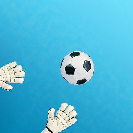 Goalkeeper catches the ball on white の写真素材