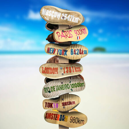 Signpost is made of old worn shoes, the distance to the citiesの写真素材