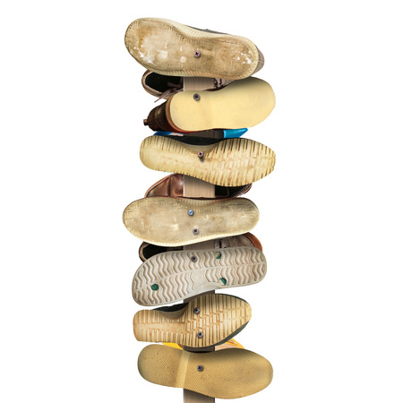 Old secondhand shoes nailed to a Board, a signの写真素材
