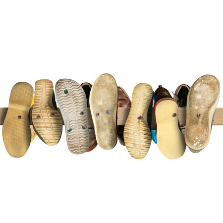 Old secondhand shoes nailed to a Board, a signの写真素材