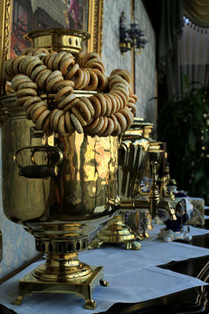 Old copper teapot, a samovar and bagels, biscuitsの写真素材