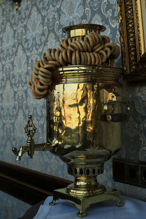 Old copper teapot, a samovar and bagels, biscuitsの写真素材