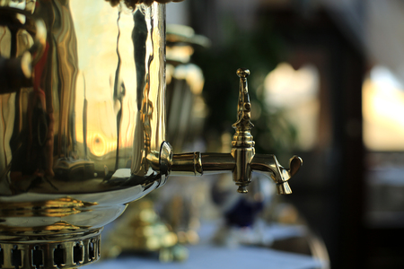 Old copper teapot, a samovar and bagels, biscuitsの写真素材