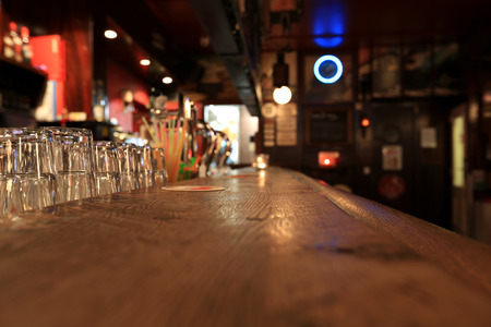 Bar, old wooden rack with glasses in the pub