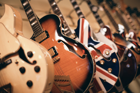 Electric guitar hanging on the wall in the shopの写真素材