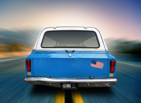 Blue car is moving along the American highwayの写真素材