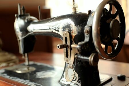 Black retro sewing machine in an old houseの写真素材
