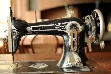 Black retro sewing machine in an old houseの写真素材