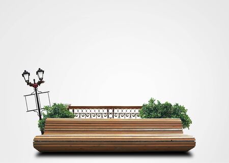 Bench in the city Park with flowers and bushesの写真素材