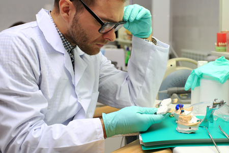 Dental technician denture with gypsum in the laboratoryの写真素材
