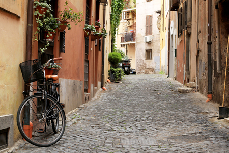 Italy, street with bicycle and flowers in Romeの写真素材