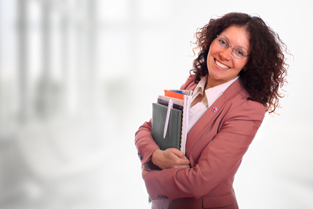 Beautiful curly young woman wearing glasses and a jacketの写真素材