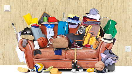 Large leather sofa with a bunch of different thingsの写真素材