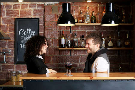 Couple at the bar with two glasses of wineの写真素材