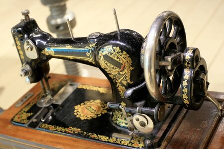 Black retro sewing machine in an old houseの写真素材