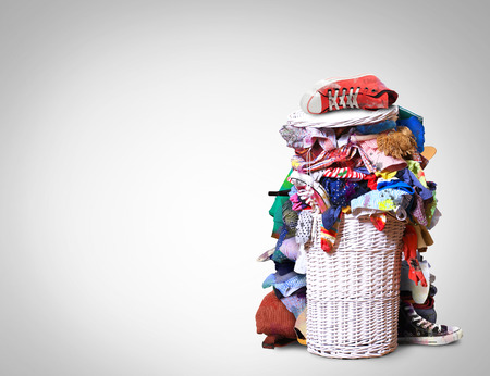 White straw basket full of dirty Laundryの写真素材