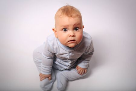 Little baby in diaper lying on bedの写真素材